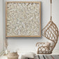 Turritella shell wall art in natural wood frame displayed in living room