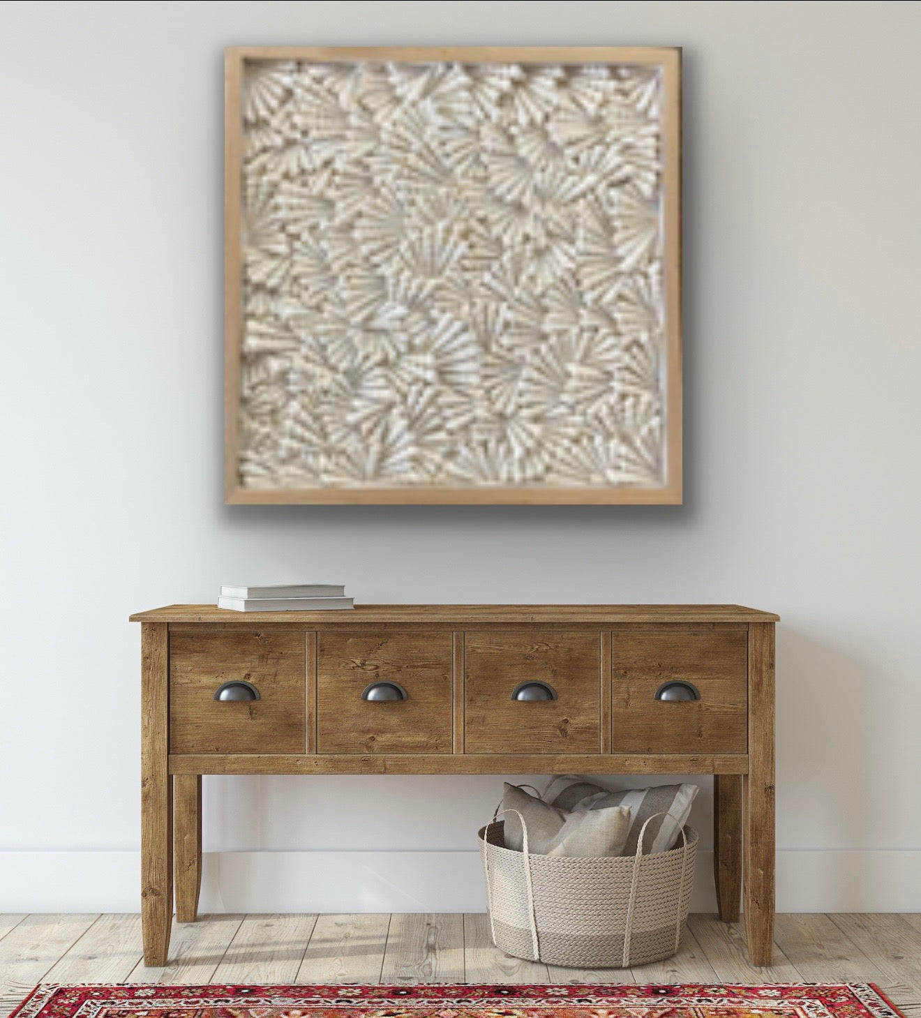 Turritella shell wall art in natural wood frame displayed above console table