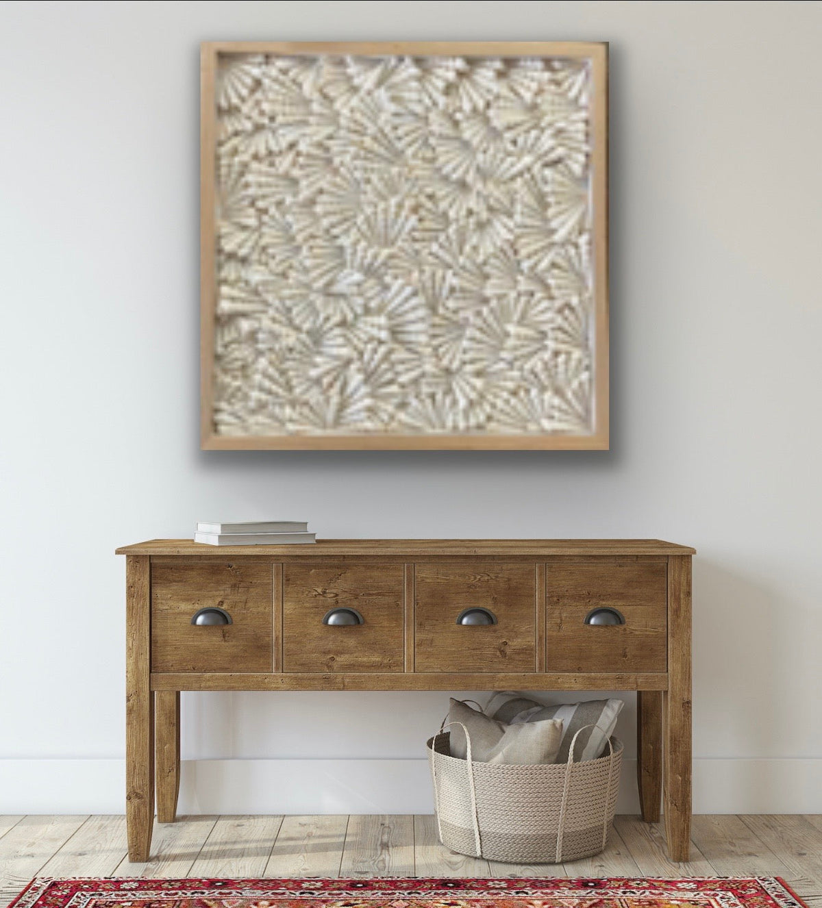 Turritella shell wall art in natural wood frame displayed above console table